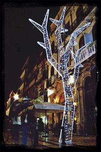 Statue of illuminated city at night
