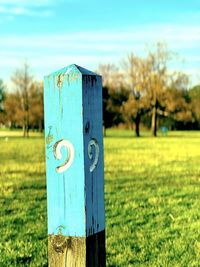 Close-up of wooden post on field