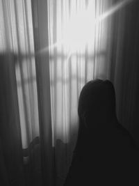 Rear view of woman at home