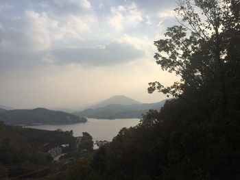 Scenic view of lake against cloudy sky