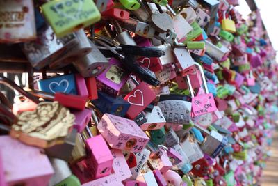 Close-up of padlocks hanging on railing
