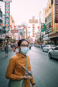 Portrait of man standing on city street