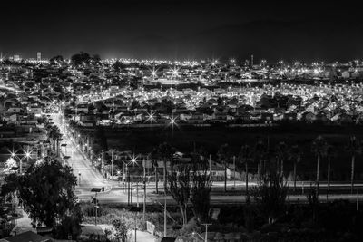 High angle view of illuminated buildings in city at night