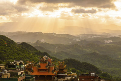 Panoramic view of building and mountains against sky