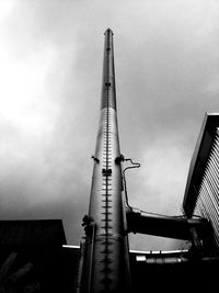 Low angle view of crane against sky