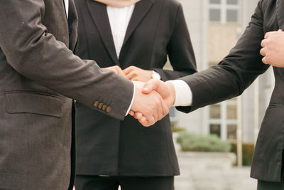 Midsection of couple holding hands