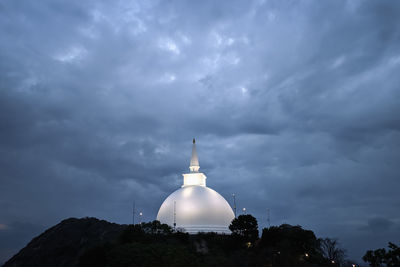 Low angle view of a building against cloudy sky