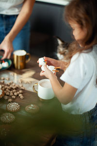 Woman holding coffee cup on table