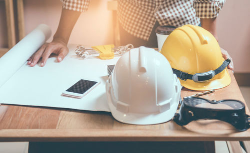 Midsection of man working on table