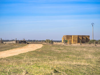 Abandoned built structure on field against sky