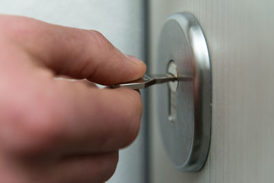 Cropped hand of man repairing key