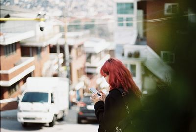 Young woman in car on street in city