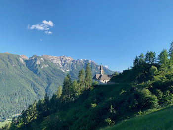 Scenic view of mountains against blue sky