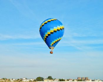 Low angle view of hot air balloon flying against sky