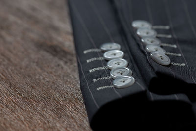 Close-up of blazer buttons on table