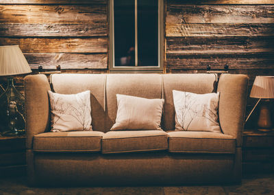 Cushions on sofa in living room at home