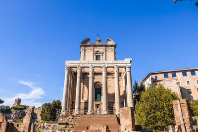 Low angle view of temple building against clear blue sky