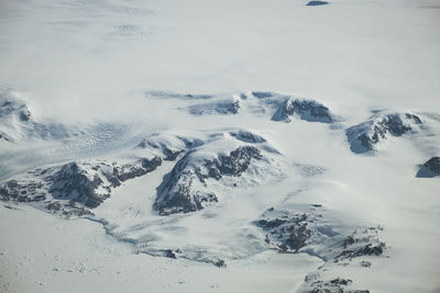 Scenic view of snow covered mountains against sky