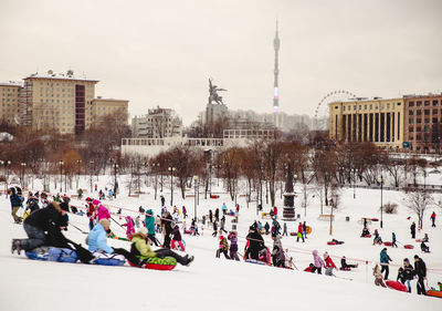 Distant view of ostankino tower in front of people enjoying during winter in city