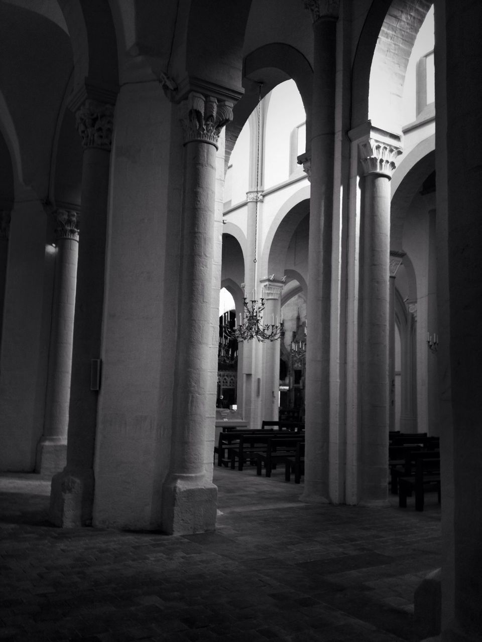 architecture, arch, architectural column, built structure, column, indoors, religion, place of worship, in a row, colonnade, church, pillar, corridor, building exterior, history, spirituality, travel destinations, incidental people, empty