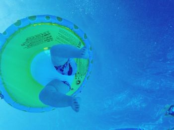 Baby swimming with inflatable ring in pool