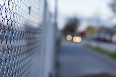 Close-up of chainlink fence in city