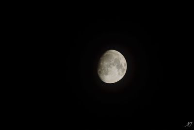 Low angle view of moon against dark sky