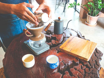 Midsection of woman with coffee cup