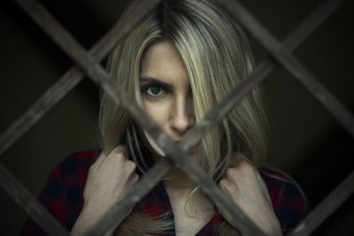 Close-up portrait of woman seen through window