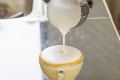 Close-up of milk pouring in coffee