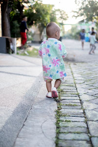 Girl walking on footpath