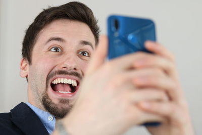 Portrait of young man using smart phone