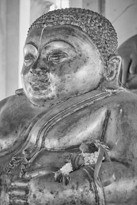 Close-up of buddha statue against building