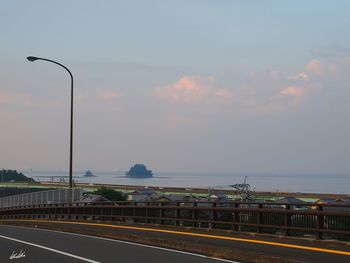 Street light on beach against sky