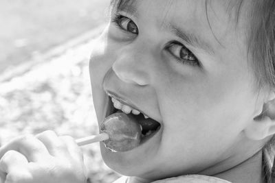 Close-up portrait of cute boy eating