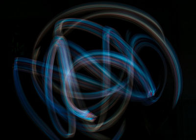 Light trails against black background