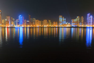 Illuminated city at waterfront