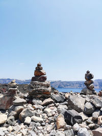 Stack of rocks against clear blue sky