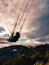Man on swing at sunset