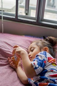 Cute girl lying on bed at home