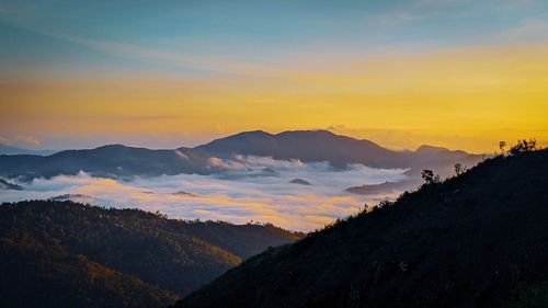 Scenic view of silhouette mountains against sky during sunset