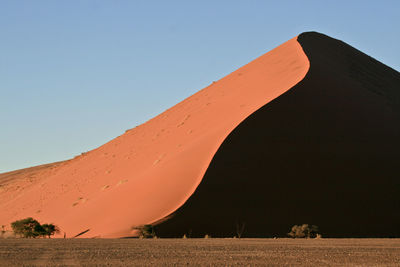 Low angle view of desert against clear sky