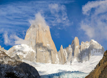 Panoramic view of snowcapped landscape against sky