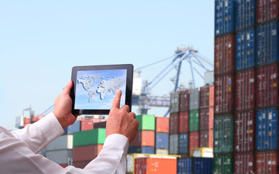 Man using smart phone against clear sky