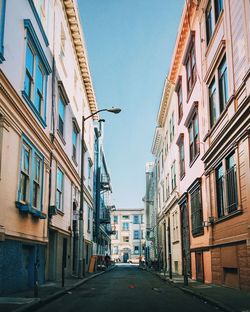 Street amidst buildings against clear sky