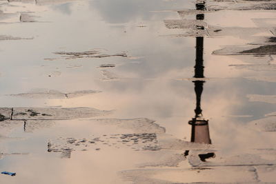 Reflection of building in puddle