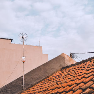 Low angle view of building roof against sky