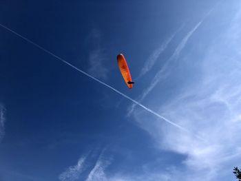 Low angle view of vapor trail against blue sky