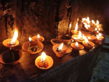 Close-up of lit candles in temple