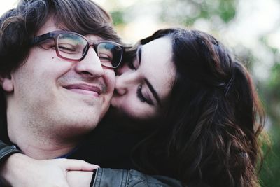 Close-up of woman kissing man